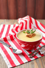 Bowl with tasty vanilla pudding on table
