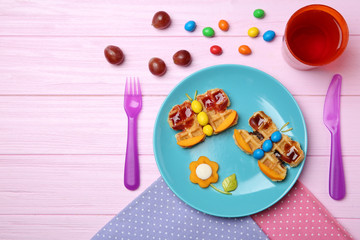 Creative breakfast for children on wooden background, top view