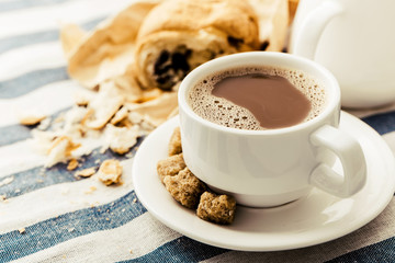 Cappuccino on a striped tablecloth. Morning coffee.