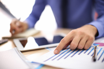 Man working at table in office, closeup. Financial trading concept