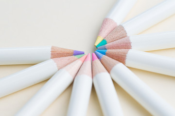 Pastel color pencils arrange in circle with copy space on light white paper background using as coloring or art for anti-stress and relaxation therapy