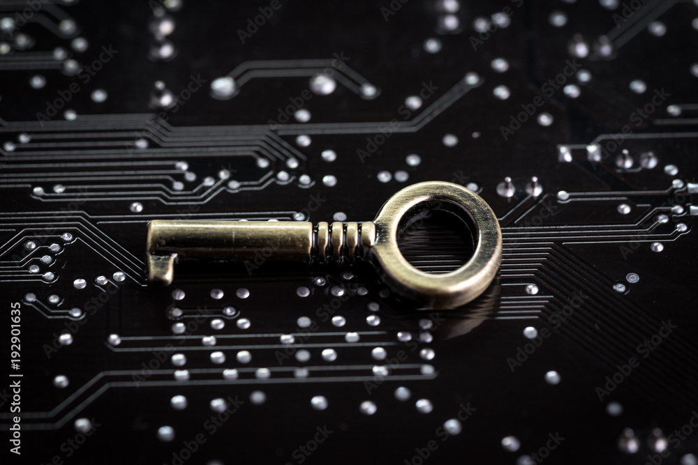 Aufkleber digital cyber safety or security encryption concept, small metal key on computer circuit board with 
