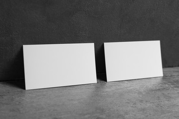Blank business cards on grey background