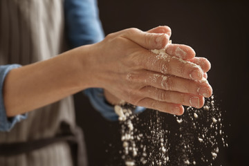 Woman with flour on black background