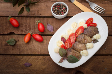 Fried chicken liver with vegetables and herbs. Wooden background. Top view