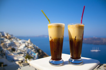 Greece Santorini island in Cyclades, coffee espresso freddo with wide sea of caldera in greek caffe