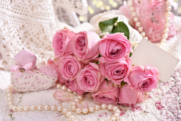 bunch of pink roses with blank card