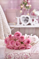 bunch of pink roses lying on the bed