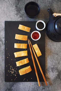 Japanese omelet roll egg sweet  with red and soy sauces. Top view