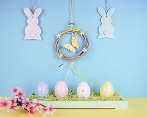 Creative easter composition with painted eggs and easter bunny.