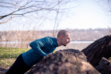 Fototapeta premium Man doing push ups outdoors
