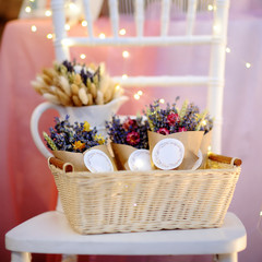 Beautiful dried flowers in paper boxes with lights on background