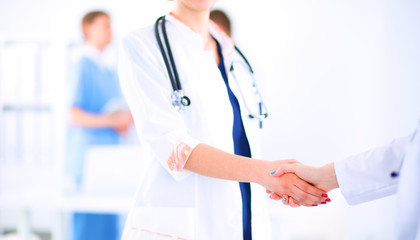 Young medical people handshaking at office