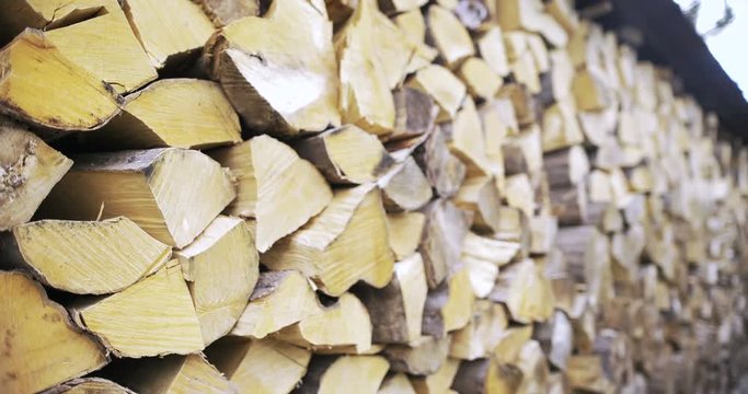 Stack of logs chopped trees. Wood ready for smoking.