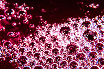 Bubbles on a red and pink liquid macro