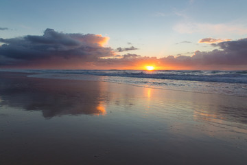 Fototapeta na wymiar Vibrant beach sunrise