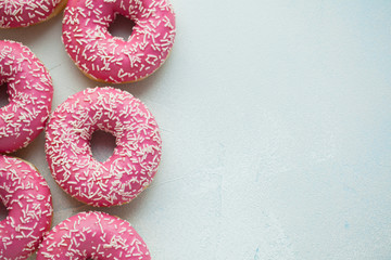 Donut. Sweet icing sugar food. Dessert colorful snack. Glazed sprinkles. Treat from delicious pastry breakfast. Bakery cake. Doughnut with frosting. Baked unhealthy round. Top view with copy space