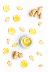 Cup of ginger tea near ginger root on white background top view pattern