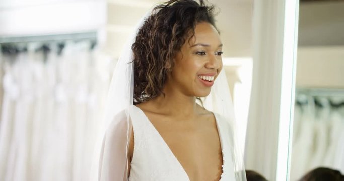 4k, Portrait of a beautiful young woman trying on a wedding dress. Slow motion.