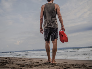 sportsman RECOVERING after crossfit workout barefoot at the beach