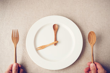 white plate with spoon and fork, Intermittent fasting concept, ketogenic diet, weight loss, food crisis - obrazy, fototapety, plakaty