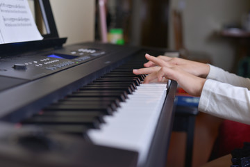 kid hands playing piano