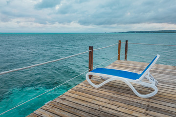 Wooden Pier and Long Blue Chairs with Nobody
