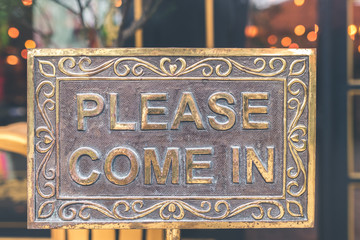Please come in vintage sign in the store. Asia.