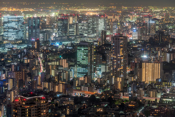 Tokyo - August 08, 2017 : Tokyo skyline night aerial view High Rise Buildings and highway car trails from Roppongi Hills Mori Tower.