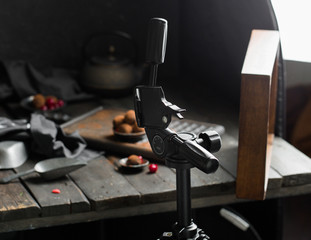 Backstage professional food photos. Chocolate truffle. Dark chocolate and cherry candy sprinkled with cocoa on a dark wooden background in rustic style. Atmospheric food photo. 
