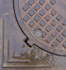 wet rusty sewer hatch. background, texture