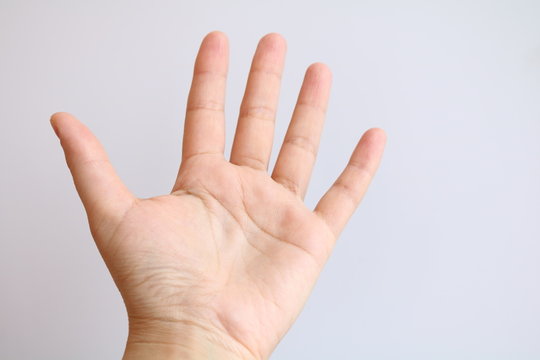 The palm of the hand is extended forward
