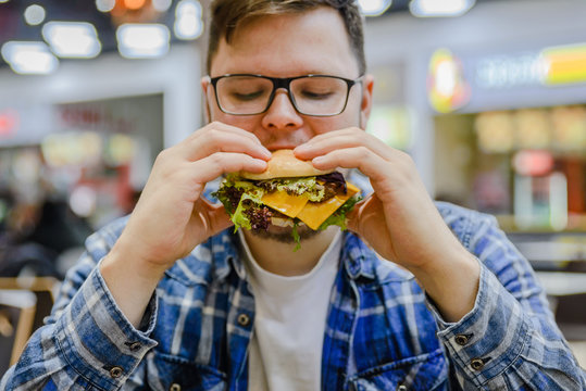 Man Eat Burger In Mall Cafe