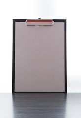 Black clipboard close-up with blank sheet of paper isolated on white background.Copy space of clean paper in the clip board. Space for text. Mock up concept