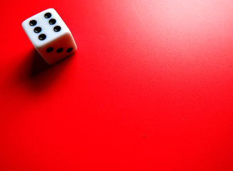 plastic dice on top of red background