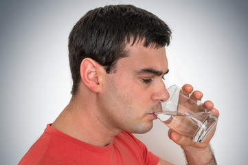 Young man drinking fresh water