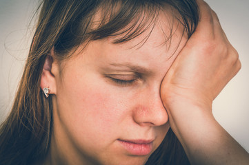 Fototapeta premium Woman with eyes pain is holding her aching eye