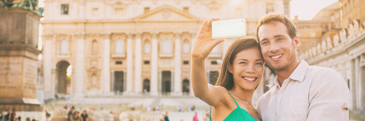 Rome tourists on honeymoon vacation taking selfie photo with phone in front of Vatican, banner...