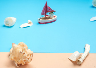 Fototapeta na wymiar Set of summer object Sea Shell,boat,coral, starfish, and sand on pastel beige and blue background.Holiday vacation backdrop.Copy space for display of product or content design.