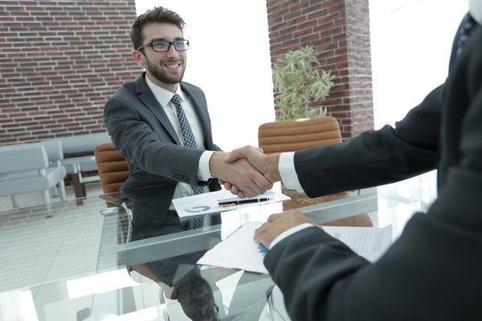 financial partners handshake after signing contract
