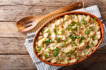 Wall murals meal dishes Portuguese food: casserole with cod, potatoes, onions and cream in a baking dish close-up. horizontal top view