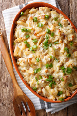 Bacalhau com natas - baked cod with potatoes, onions and cream closeup. vertical top view