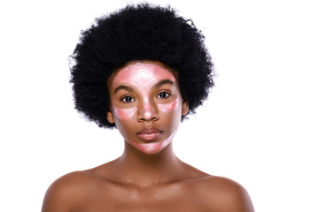 Young African woman with a purifying mask on her face