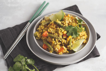Vegetarian curry rice with vegetables in a gray plate.  Healthy vegan food concept, detox, vegetable diet.