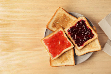 Delicious toasts with sweet jams on table