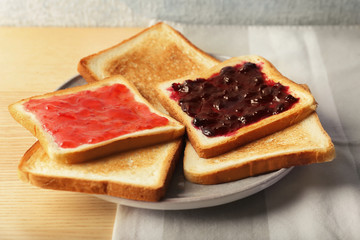 Delicious toasts with sweet jams on table