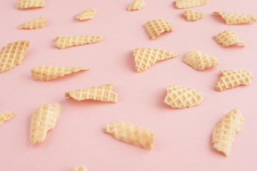 Background from pieces of waffle cone on pink background