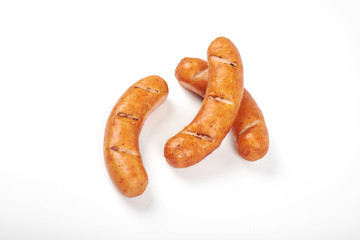 Grilled chicken sausages isolated on a white background