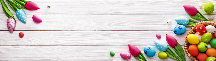 Easter Eggs and Decorative Tulips on White Wooden Background