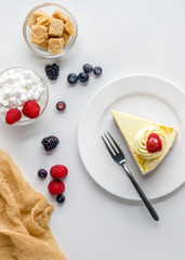 top view of piece of appetizing dessert with berries on white surface